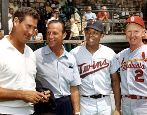 From left, Ted Williams, Stan Musial, Tony Oliva and Red Schoendienst share a moment at the 1966 Hall of Fame Game at Cooperstown's Doubleday Field. (National Baseball Hall of Fame and Museum)