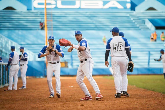 Players for the Industriales team warm up on the field prior to the game against the Ciego de Avila at Estadio Latinoamericano on January 17, 2015 in Havana, Cuba. The stadium was the singular home of Cuban Winter League games in the 1950s. (Jean Fruth / National Baseball Hall of Fame)