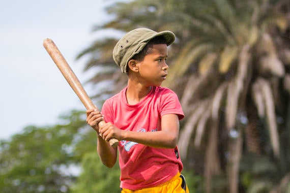 A young kid plays baseball in a park on the outskirts of Havana on January 11, 2015 in Havana, Cuba. (Jean Fruth / National Baseball Hall of Fame)