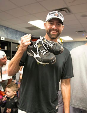 Giants pitcher Jeremy Affeldt holds the spikes he wore during Game 7 of the World Series. Affeldt was the winning pitcher in the game that clinched the Fall Classic for the Giants. (Jean Fruth/National Baseball Hall of Fame Library)