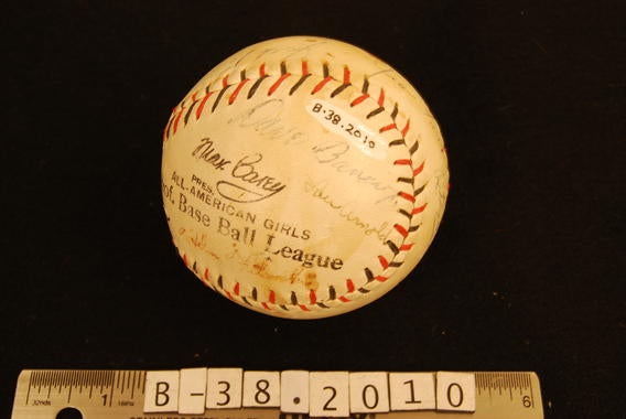 Dave Bancroft joined some of the women he managed in the All-American Girls Professional Baseball League in signing this league ball - B-38-2010  (Milo Stewart Jr./National Baseball Hall of Fame Library)