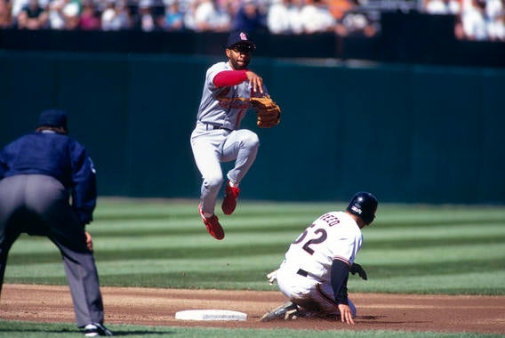 St. Louis Cardinals shortstop Ozzie Smith forces out San Francisco Giants base runner Jeff Reed at second base as he turns a double play during their game at Candlestick Park in San Francisco, California in 1993 - BL-BradMangin0702 (Brad Mangin/National Baseball Hall of Fame Library)