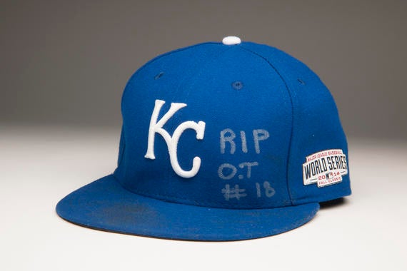 In Game Six, Kansas City’s 10-0 victory, Royals starting pitcher Yordano Ventura dominated the Giants for seven innings. The Dominican fireballer’s cap from the game bears his tribute to a friend, Oscar Taveras, the promising young St. Louis Cardinals outfielder who was killed in a car accident two days earlier. - B-178-2014 (Milo Stewart, Jr./National Baseball Hall of Fame Library)