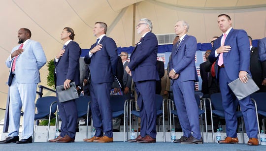 Vladimir Guerrero, Trevor Hoffman, Chipper Jones, Jack Morris, Alan Trammell and Jim Thome stand during the national anthem at the 2018 Hall of Fame <em>Induction Ceremony</em>. 