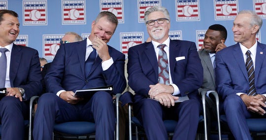 Class of 2018 members (from left) Trevor Hoffman, Chipper Jones, Jack Morris and Alan Trammell share a light moment during the July 29 <em>Induction Ceremony</em> in Cooperstown. (Milo Stewart Jr./National Baseball Hall of Fame and Museum)